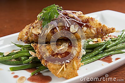 Almond Crusted Tilapia with Green Beans Stock Photo