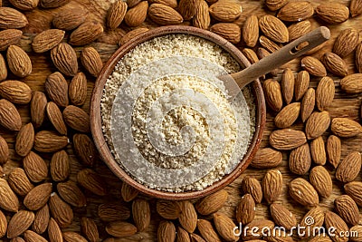 Almond flour and almonds in bowls. Gluten free food concept. Stock Photo