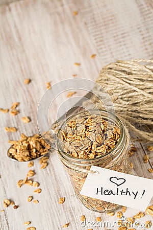 Almond Granola With Heart Healthy Tag On Jar And Spoon Stock Photo