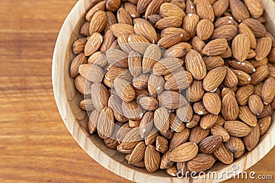 Almond kernel in a bowl. Background view from above. Healthy food. Stock Photo