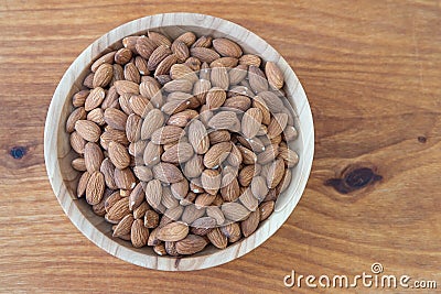 Almond kernel in a bowl. Background view from above. Healthy food. Stock Photo