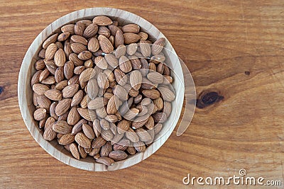 Almond kernel in a bowl. Background view from above. Healthy food. Stock Photo