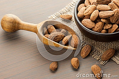 Almonds background concept with wooden shovel Stock Photo