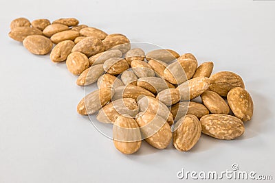 Almonds seeds on a white surface Stock Photo