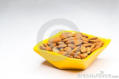 Almonds in yellow bowl Stock Photo