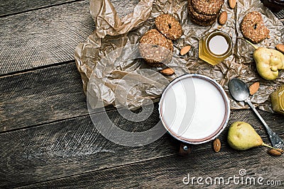Almonds pears Cookies and milk on wooden table Stock Photo