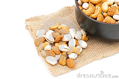 Almonds Pistachio and Cashews on a sack of cloth white background Stock Photo