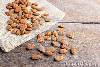 Almonds pour on wooden Stock Photo