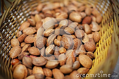 Almonds unshelled nuts in basket, fresh and raw Stock Photo