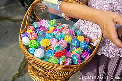 Almsgiving with alms flowers ribbon-flowers for giving alms to make merit in Buddhism religious traditional in Thailand Stock Photo