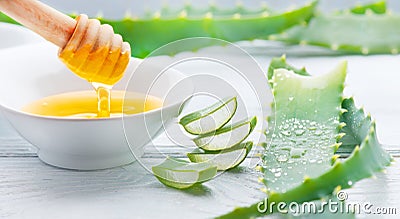 Aloe Vera with honey closeup on white wooden background. Sliced Aloevera natural organic renewal cosmetics, alternative medicine Stock Photo