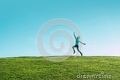 Alone asian Woman Jumping for Joy on a Grass Hill above horizon line One happy slim girl fly in a green field against blue summer Stock Photo