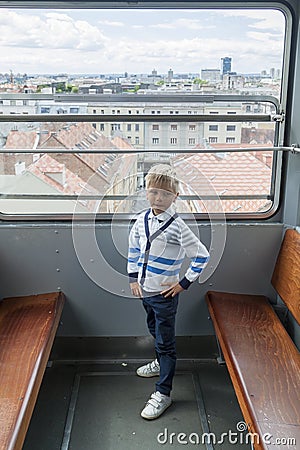 alone boy climb in an empty funicular and look at the panorama of the city of Zagreb Stock Photo