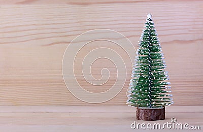 Alone christmas tree with wooden background. Wallpaper. Stock Photo