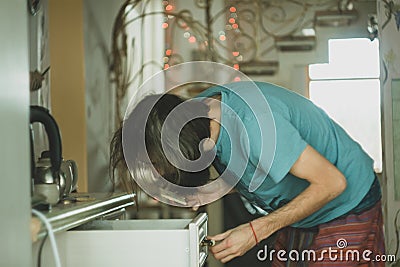 Alone hungry man search food at kitchen Stock Photo