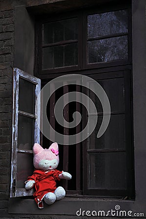 Alone rag baby at windowsill Stock Photo