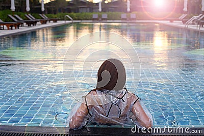 Fashion woman raincoat lifestyle relaxing pools Stock Photo