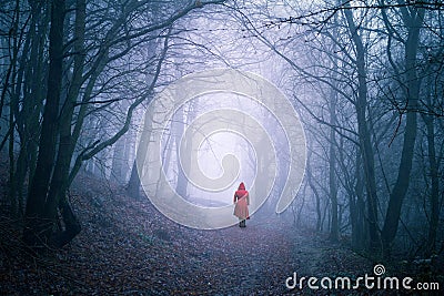 Alone woman in dark forest Stock Photo