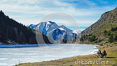 Trailside Tranquility: Hikers Rest Amidst Spectacular Pyrenees Scenery. Stock Photo