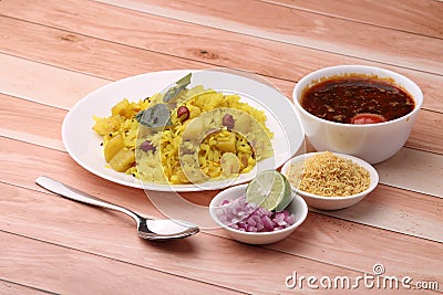 Aloo/Kanda Poha or Tarri Pohe with spicy chana masala/curry. Served in ceramic plate. Stock Photo