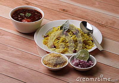 Aloo/Kanda Poha or Tarri Pohe with spicy chana masala/curry. Served in ceramic plate. Stock Photo