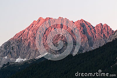 Alpen glow across a mountain range in bavaria Stock Photo