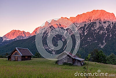 Alpen glow across a mountain range in bavaria Stock Photo