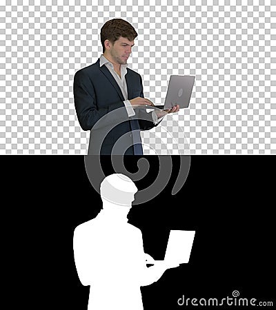 Businessman using laptop computer standing Great news, Alpha Cha Stock Photo