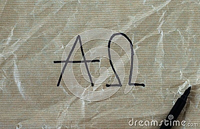 Alpha and Omega letters handwritten on crumpled paper with black marker Stock Photo