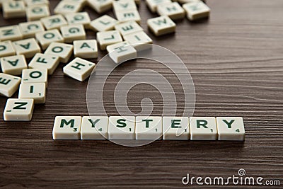 Alphabet block with Mystery word wooden table Stock Photo