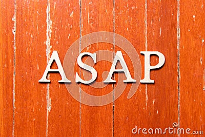 Alphabet in word ASAP Abbreviation of as soon as possible on old red color wood plate background Stock Photo