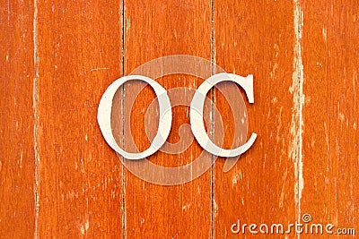 Alphabet in word OC Abbreviation of opportunity cost or original content, character on old red color wood plate Stock Photo
