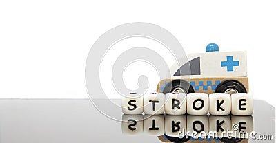 alphabet letters spelling the word stroke and a toy ambulance Stock Photo