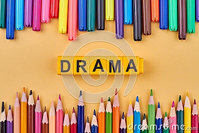 Alphabet letters in word drama on color background with pencils. Stock Photo