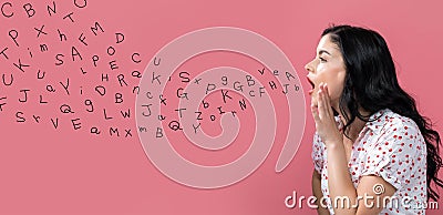 Alphabet letters with young woman speaking Stock Photo