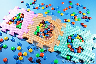 Alphabet Puzzles and Chocolate Lollies Stock Photo