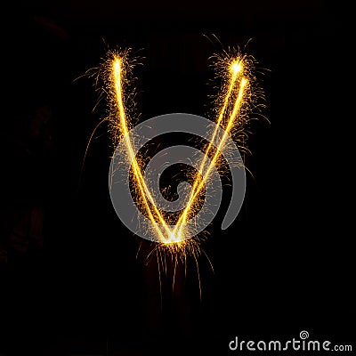 Alphabet sparklers on black background single letter Stock Photo