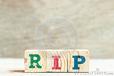Alphabet in word RIP abbreviation of rest in peace on wood background Stock Photo