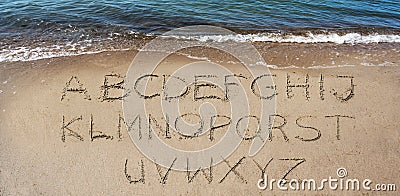 Alphabeth handwritten in the sand on the beach to make your own text Stock Photo