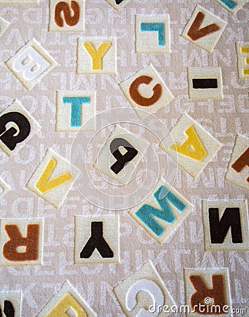 Alphabets on a Fabric Carpet Surface Stock Photo