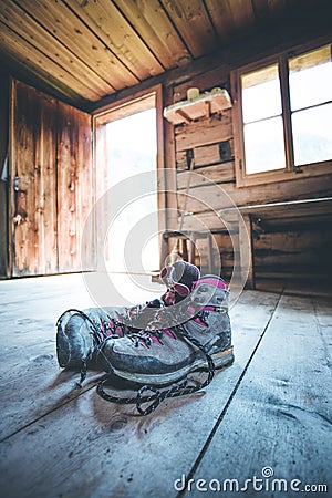 Alpine boots on rustic wood floor in an abandoned mountain chalet in Austria Stock Photo