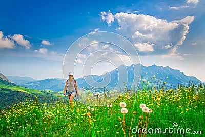 Alpine hiking lonely girl in a flowery meadow Stock Photo