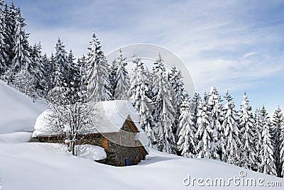 Alpine hut under snow Stock Photo