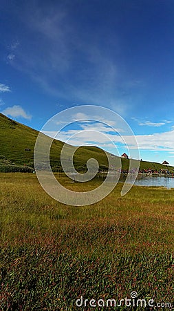 Alpine meadow with lake in himalaya mountains Stock Photo