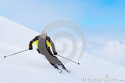 Alpine skier on piste running downhill Stock Photo