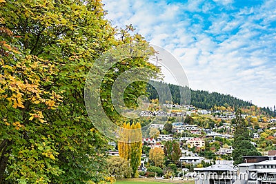 Alpine village colorful hillside residences mingled with luxuriant fall foliage Stock Photo