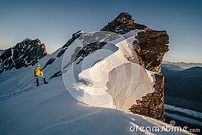 An alpinist climbing alpine peak in Switzerland Stock Photo