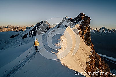 An alpinist climbing alpine peak in Switzerland Stock Photo