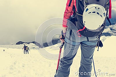 Alpinist looking down the slope. Stock Photo