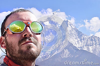 Alpinist looking at summit, mountain background Stock Photo